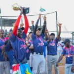 Joseph Wani (Pitcher, South Sudan) of the Samurai United lifts the Nairobi Baseball Community Series Championship Trophy alongside teammates from Kenya, Japan and Uganda during the 2nd Annual Nairobi Baseball Championship Festival at the Nairobi Field of Dreams at JKUAT in Juja.