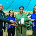 Simon Ng’ang’a, Secretary of the Ngong Road Forest Association (left), Dipna Shah,
Sustainability Lead at I&M Bank (second left), and Christine Sidi from the bank’s
Sustainability team (right) hand over a uniform kit to Salome Wambui, a scout at the Ngong
Road Forest Association Sanctuary during the Project Imaarisha uniform handover by the
I&M Foundation.