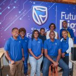 Staff of the Stanbic Kenya Foundation during the handover; The Head of Stanbic Foundation, Mercy Githanji addresses students of ACK Kiamuringa School in Embu County