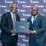 NCBA Group Director Retail Banking Dennis Njau (Left) gifts KEPROBA's Principal Economic Officer Kevin Oluoch, Principal Economic Officer during the NCBA SME Exporters Forum.